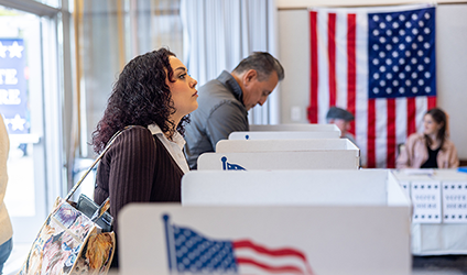 Image of woman at voting booth