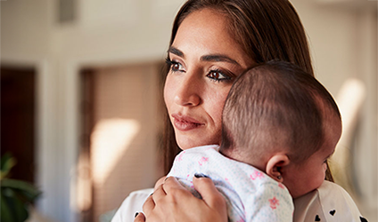 hispanic woman holding a baby