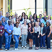 CRT workshop attendees standing in front of a building for a group photo