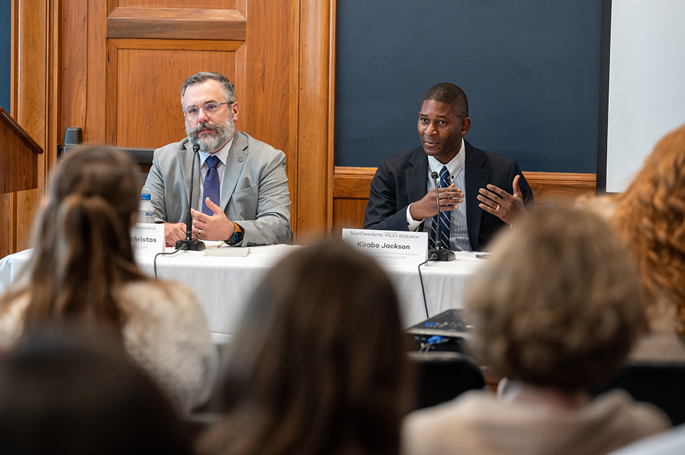 Andrew Papachristos and Kirabo Jackson sit at a table in a DC conference room 