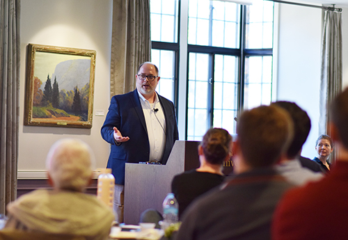 Erik Nisbet shares remarks at a podium