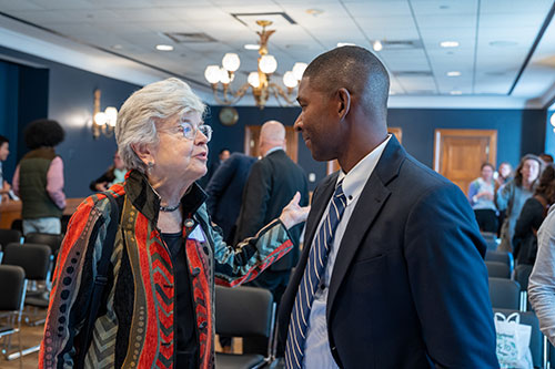 Fay Cook speaks to Kirabo Jackson at a Capitol Hill policy briefing