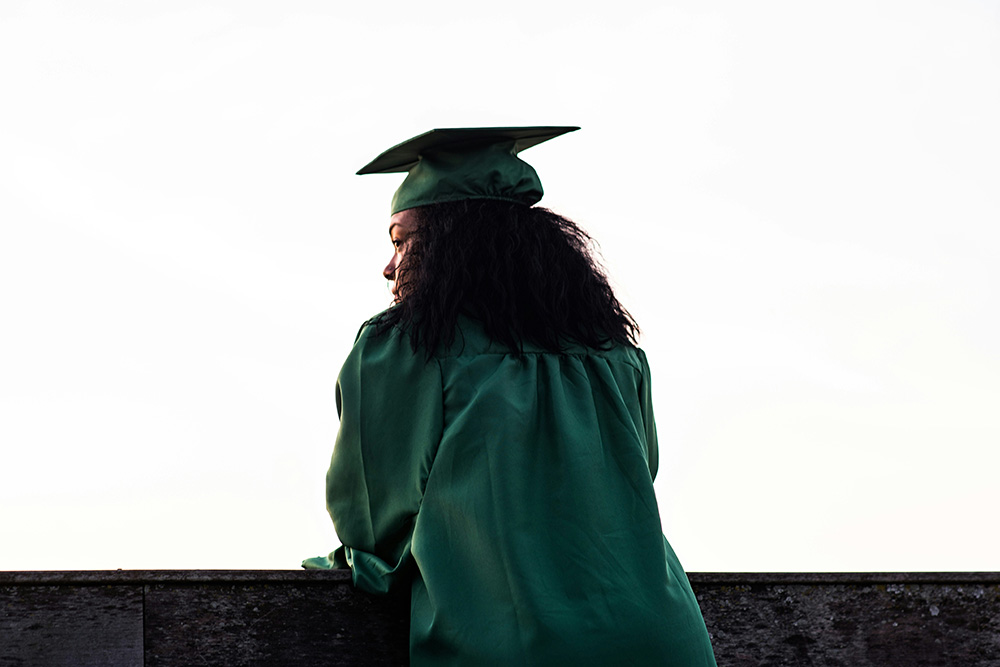 woman wearing graduation cap and gown