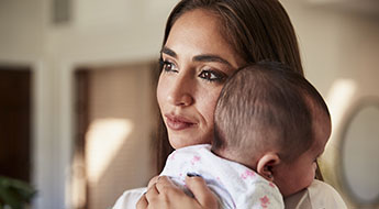 Hispanic mother holding her baby