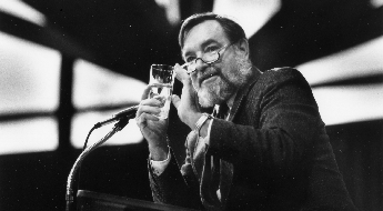 Black and white picture of speaker at a microphone