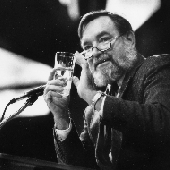 Black and white picture of speaker at a microphone