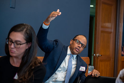 attendee of policy briefing asks a question