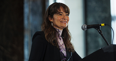 Soledad McGrath at a podium at CORNERS conference