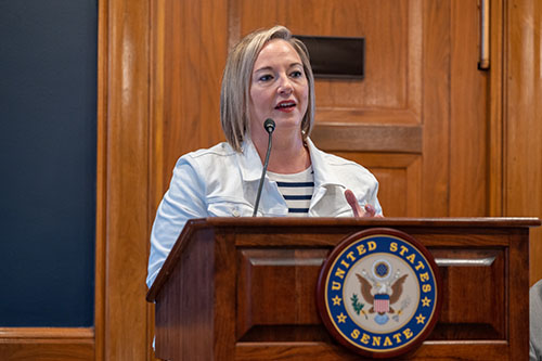 Stefanie Deluca speaks in a conference room on Capitol Hill