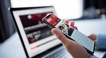 Image of woman scrolling on news site