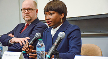 Panelist speaking into a microphone