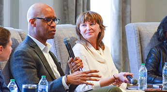 Panelist speaking into a microphone