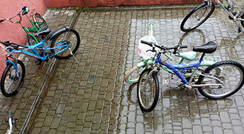 Bicycles stand on wet cobblestones in the rain in Kornalovichi village in western Ukraine.